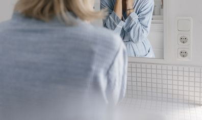 Woman looking in mirror