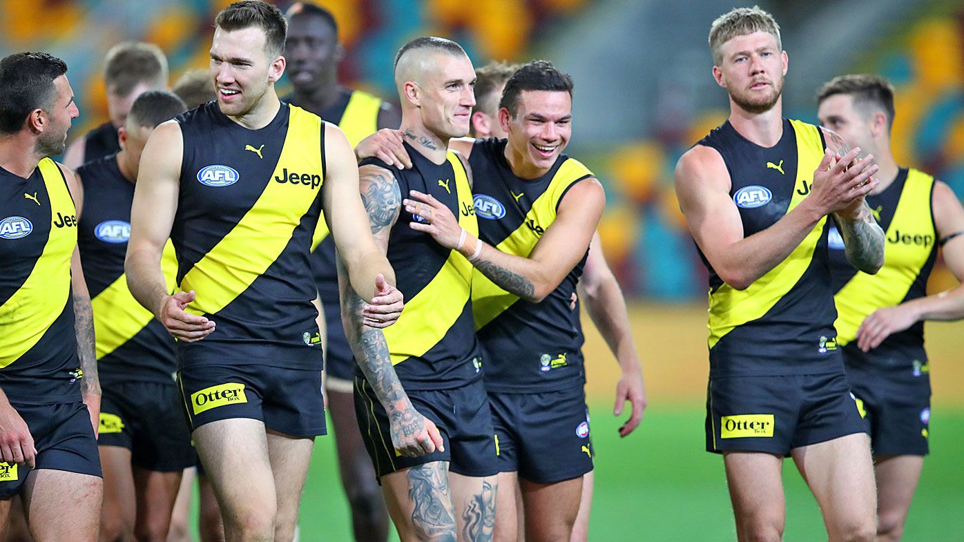 Dustin Martin and Sydney Stack (centre) celebrate a win in round 12