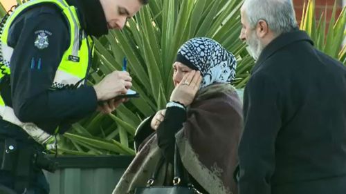 A distressed neighbour speaks with police. (9NEWS)