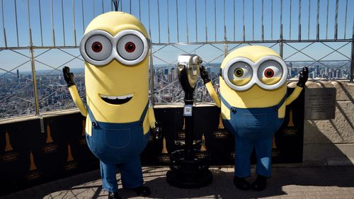 Minion characters Kevin, left, and Bob pose on the 86th floor observatory deck at the Empire State Building to celebrate the new Minions film.