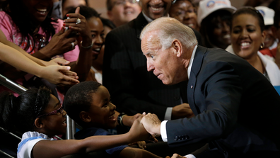 Vice President Joe Biden greets Lawrence Smith, 8, and Madison King, 9, both of Van Buren Township, Mich., during a campaign stop at Renaissance High School, Wednesday, Aug. 22, 2012, in Detroit. (AP Photo/Paul Sancya)