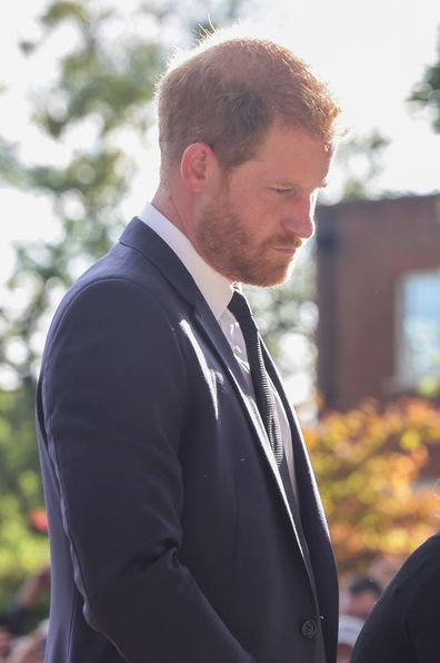 Prince Harry, Duke of Sussex looks at floral tributes laid by members of the public on the Long walk at Windsor Castle on September 10, 2022 in Windsor, England.