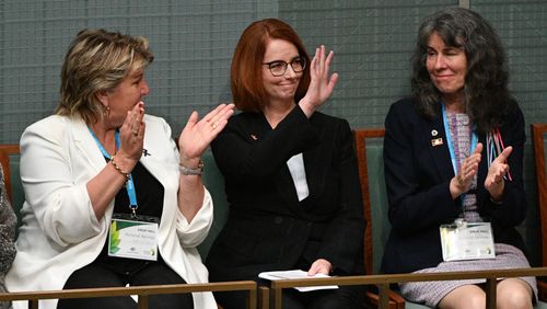 Former prime minister Julia Gillard listens to the apology.