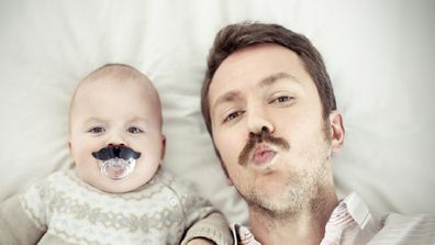 Portrait of a father with his son, both with mustaches