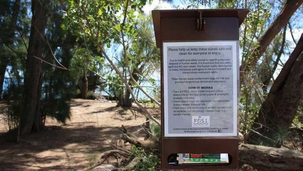 Sign post with waste bags for poo on Florida's Indian River Lagoon