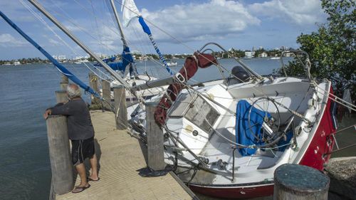 A man watches the water in search of his boat in the port of Watson island after the passing of Hurricane Irma in Miami Beach. (AAP)