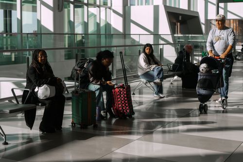 Travelers wait at LaGuardia International Airport on Saturday, Nov. 8, 2025, in New York. (AP Photo/Olga Fedorova)