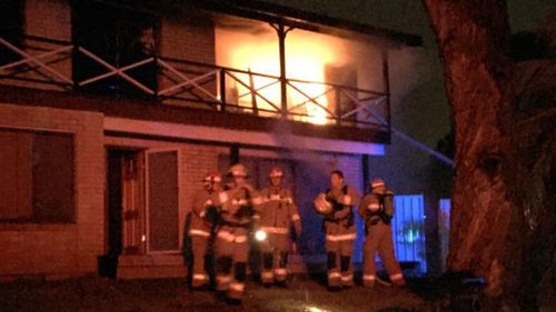 Firefighters outside the house that was struck by lightning in Kellyville. (9NEWS)