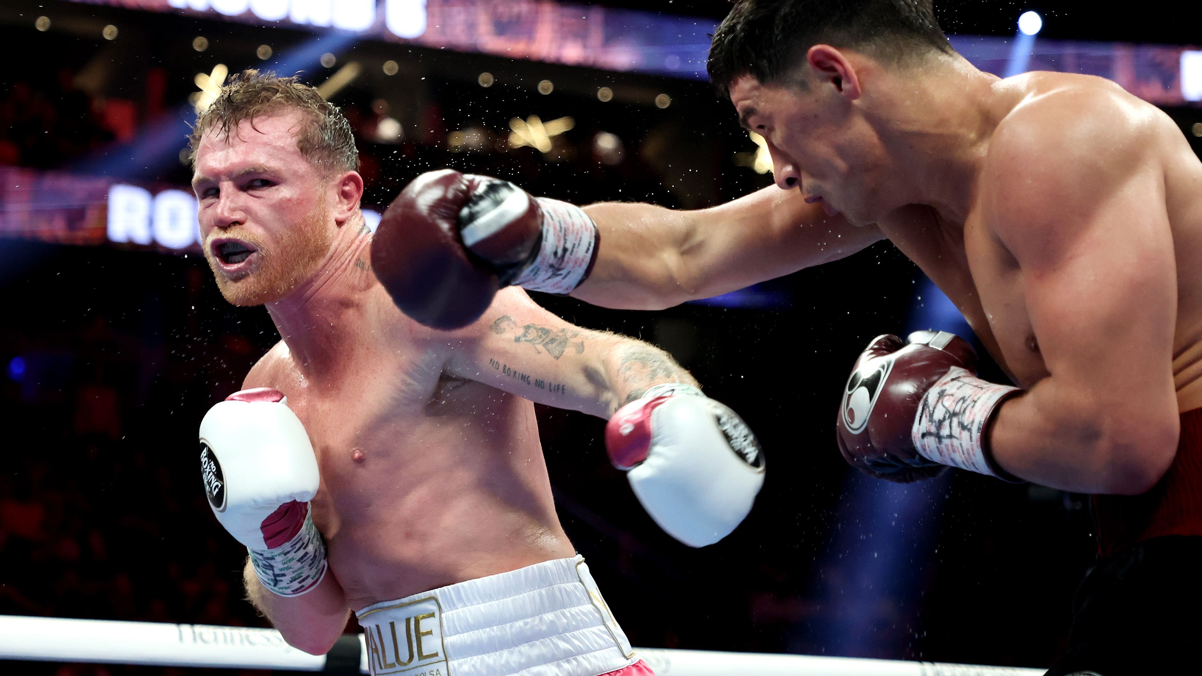 Canelo Alvarez (L) exchanges punches with Dmitry Bivol during their WBA light heavyweight title fight at T-Mobile Arena.