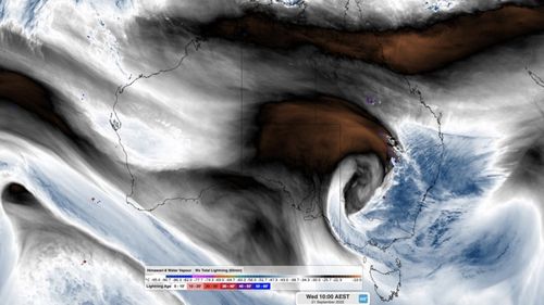 This satellite image shows the thick band of cloud passing over eastern Australia ahead of a well-defined upper-level low pressure system.