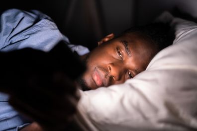 Watching Cell Phone Before Sleep At Night In Bedroom