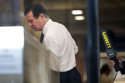 In this June 15, 2018 file photo, former campaign chairman for President Donald Trump Paul Manafort, goes through security as he arrives at federal court, in Washington. The way President Donald Trump sees it, Al Capone, the most famous gangster in American history, got off easy compared to Manafort. On Wednesday, Aug. 1 as Manafort stands trial for charges that include tax evasion, the same crime that landed Capone in Alcatraz, the president took to twitter to complain that Manafort is being treated far harsher than "Public Enemy Number One." (AP Photo/Jacquelyn Martin, Fi
