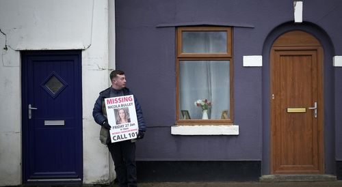 People line the streets with placards asking for information on missing Nicola Bulley in the village of St Michael's on Wyre on February 10, 2023 in Preston, England.