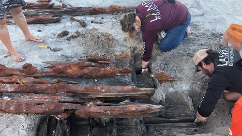 Dorothy Rowland and Nick Budsberg, both members of the St. Augustine Lighthouse Maritime Archaeological Program, examine the wreck off Crescent Beach.