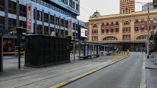 MELBOURNE, AUSTRALIA - SEPTEMBER 18: A deserted Elizabeth Street tram stop near Flinders Street station on September 18, 2021 in Melbourne, Australia. Anti-lockdown protests have been planned in Melbourne despite current COVID-19 restrictions prohibiting large outdoor gatherings. Victoria police are shutting down the public transport network in the CBD in a bid to discourage protestors. Metropolitan Melbourne is currently subject to lockdown restrictions as health authorities work to contain the