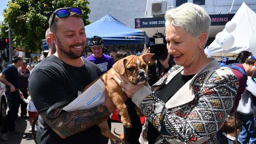 Kerryn Phelps pats a dog while campaigning in Wentworth.