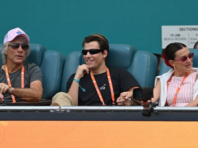 MIAMI GARDENS, FL - MARCH 27: Jon Bon Jovi, from left, Jake Bongiovi and Millie Bobby Brown are seen during the women's semifinals match at the Miami Open on March 27, 2025, at Hard Rock Stadium in Miami Gardens, Florida. (Photo by Michele Eve Sandberg/Icon Sportswire via Getty Images)