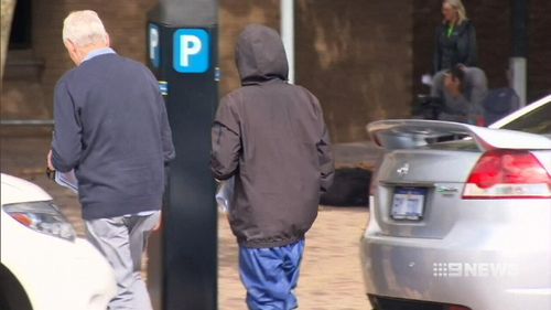 The 14-year-old boy was seen leaving children's court barefoot and with his hand bandaged. (9NEWS)