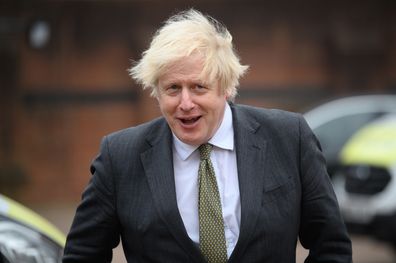 UXBRIDGE, ENGLAND - DECEMBER 17: Britain's Prime Minster Boris Johnson speaks with police officers as he makes a constituency visit to Uxbridge police station on December 17, 2021 in Uxbridge, England. (Photo by Leon Neal/Getty Images)