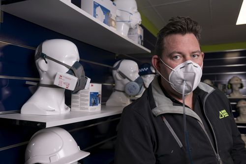 Director of On Site Safety Australia, Chris Bellamy demonstrating testing of a faulty face mask. Australia has been flooded with counterfeit mask since the coronavirus pandemic.