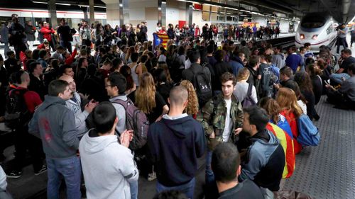 Demonstrators, most of them students, block the tracks at Sants train station during a protest against the imprisonment of pro-independence leaders and to demand their freedom, in Barcelona. (AAP)