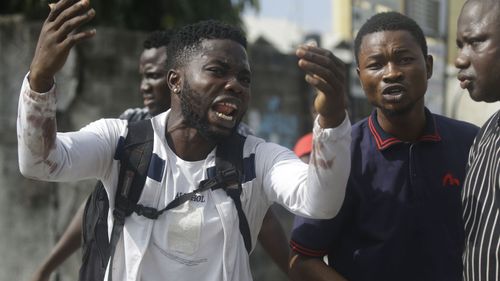 Alister, a protester who says his brother Emeka died from a stray bullet from the Army, reacts while speaking to Associated Press. 