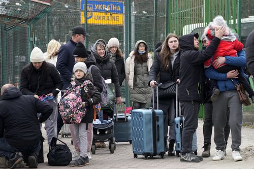 People fleeing the conflict from neighbouring Ukraine, arrive at the border crossing in Medyka, southeastern Poland, on Friday, Feb. 25, 2022.