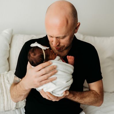 Mark Bowness cuddles up with newborn daughter Mahalia.