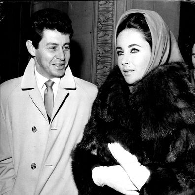 Fisher Escorts Elizabeth Taylor From Hospital -- Film star Elizabeth Taylor, who has been ill since September with a mystery sickness finally diagnosed as a virus infection, leaves the London clinic with her husband, singer Eddie Fisher, this evening (Thursday). Her illness the epic 'Cleopatra', in which she is to play the title role. November 17, 1960. (Photo by Reuterphoto).