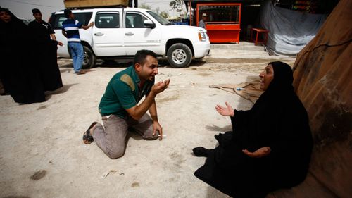 Iraqis mourn after they lost five members of their family in the bombing. (AFP)