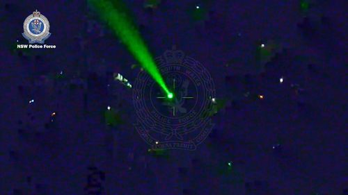 A man has been charged after allegedly pointing a laser at a police helicopter