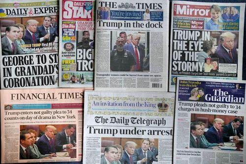 A selection of British national newspaper front pages for Wednesday April 5, 2023, in London, showing their coverage of former President Donald Trump as he appeared in court for his arraignment in New York, Tuesday. Trump surrendered to authorities Tuesday after being indicted by a New York grand jury on charges related to hush-money payments at the height of the 2016 presidential election.