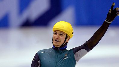 Steven Bradbury of Austrailia crosses the finish line to win the men's 1000 meter short track speed skating race