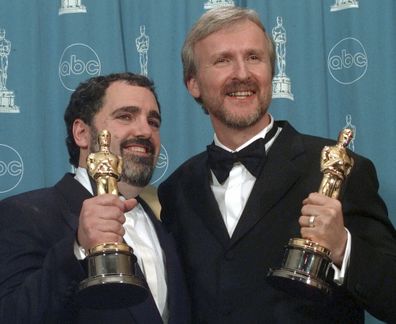 FILE - James Cameron, right, and Jon Landau hold the Oscars for Best Picture for the film "Titanic" at the 70th annual Academy Awards at the Shrine Auditorium in Los Angeles, March 23, 1998. Landau, an Oscar-winning producer who worked closely with director Cameron on Titanic" and the Avatar series, has died, announced in a statement Saturday, July 6, 2024. (AP Photo/Reed Saxon, File)