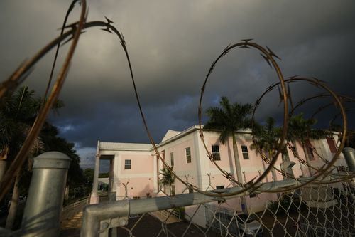 A fence topped with barbed wire surrounds the Magistrate Court building, where FTX founder Sam Bankman-Fried was expected to appear 