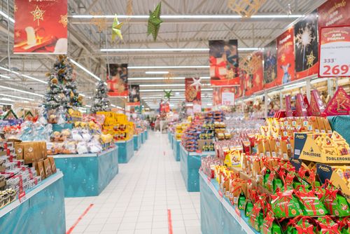 Christmas decorations line a supermarket.