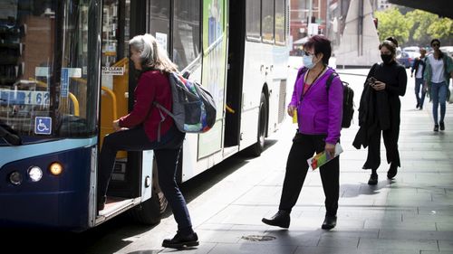 People with and without out Masks due to COVID-19 at Bus stops in George Street, Sydney.  12th October 2020.