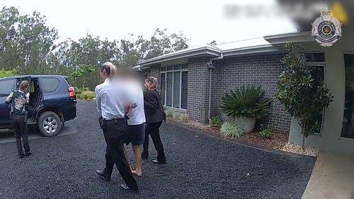 The husband of Frances Crawford has been arrested over her death, months after she was found dead at her Queensland home next to a ride-on lawn mower.