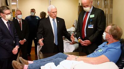 Vice President Mike Pence, center, visits a patient who survived the coronavirus and was going to give blood during a tour of the Mayo Clinic Tuesday, April 28, 2020, in Rochester, Minn. 