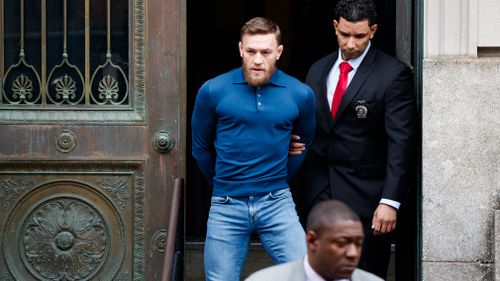 McGregor leaves a New York City police precinct after he turned himself and was arrested and charged with three counts of assault and one count of criminal mischief in Brooklyn. (EPA/AAP)