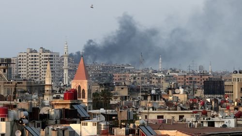 Smoke rises from the Jobar neighbourhood in west Damascus, one day after the attack in August 2013. (AAP)