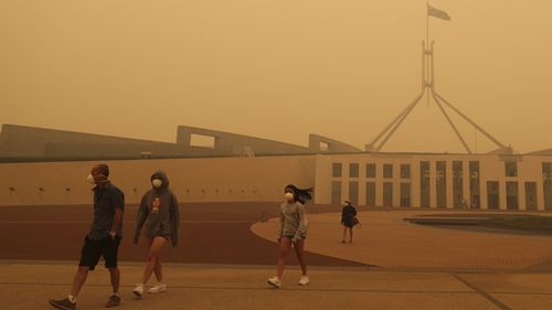 Visitors to Parliament House forced to wear face masks after smoke from bushfires blankets Canberra in a haze with hazardous air quality, on Sunday.
