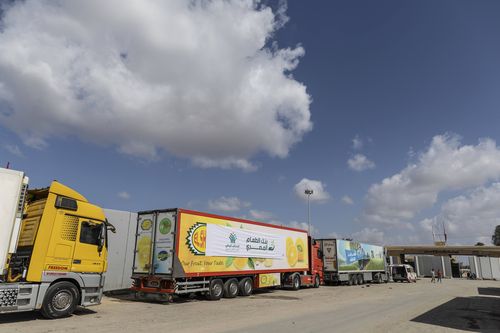 Aid convoy trucks wait at the Rafah border crossing for clearance to enter Gaza on October 19, 2023 in North Sinai, Egypt. 