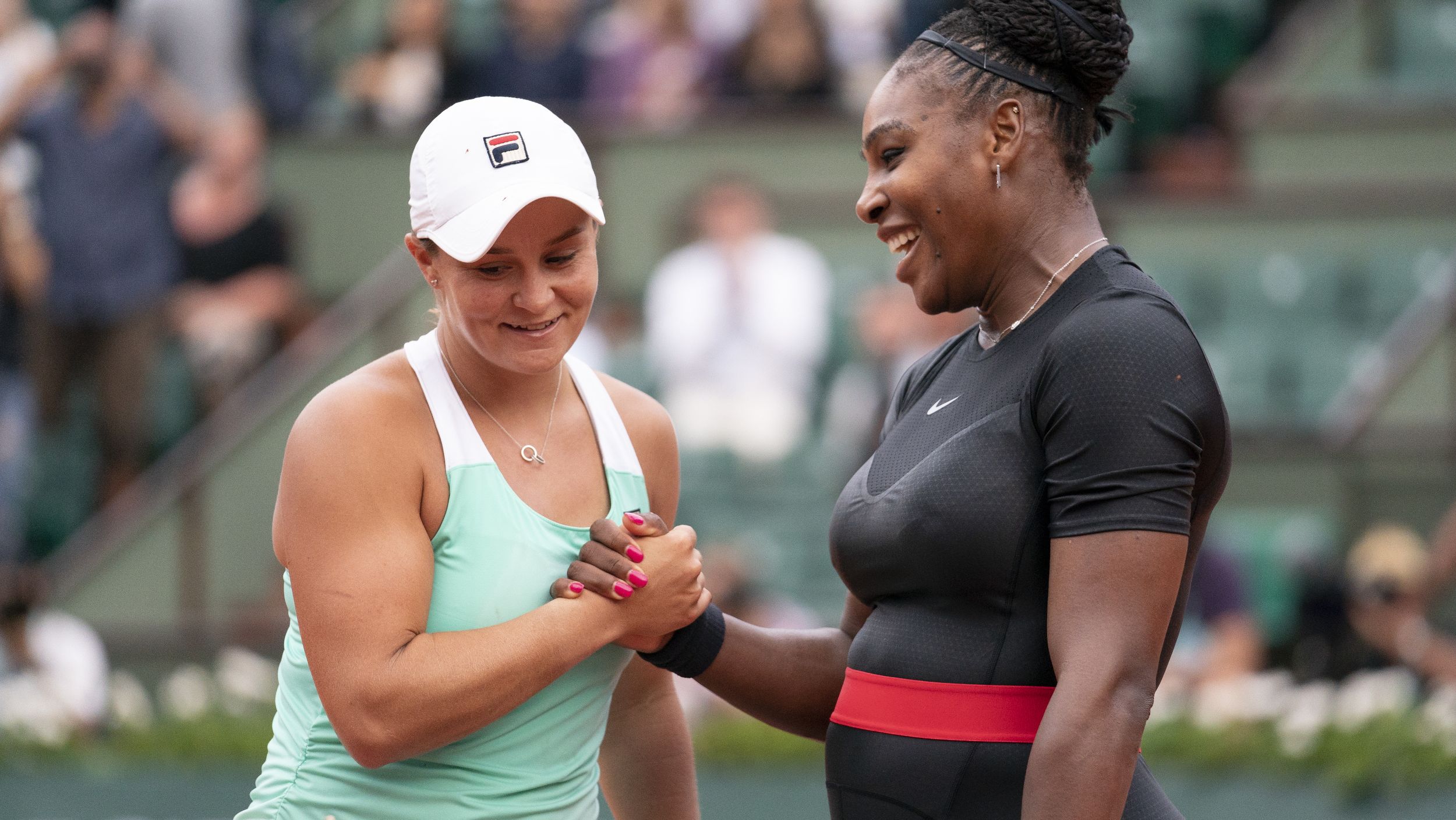 Serena Williams of The United States is congratulated on victory by Ashleigh Barty of Ausralia following their singles match during the 2018 French Open.