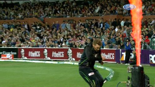 A burst of flame sends the Aussie T20 captain stumbling back.