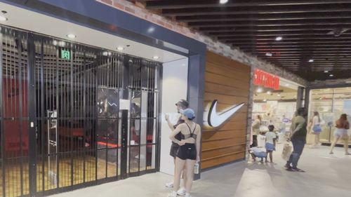 The front of a Nike store that is shut.
