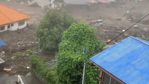 This grab taken from handout video released by a local resident and received via Jiji Press on July 3, 2021 shows mud and debris at the scene of a landslide.