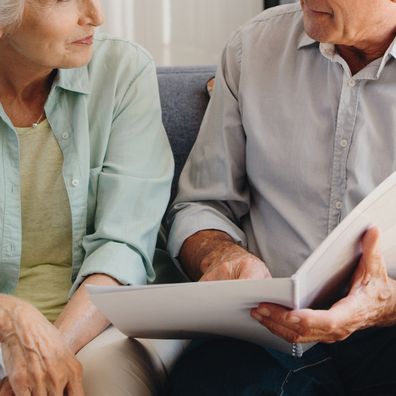 Senior and retired couple talking with finance documents in meeting with lawyer, planning retirement and will paperwork together in home. Mature man and woman in discussion about pension with advisor