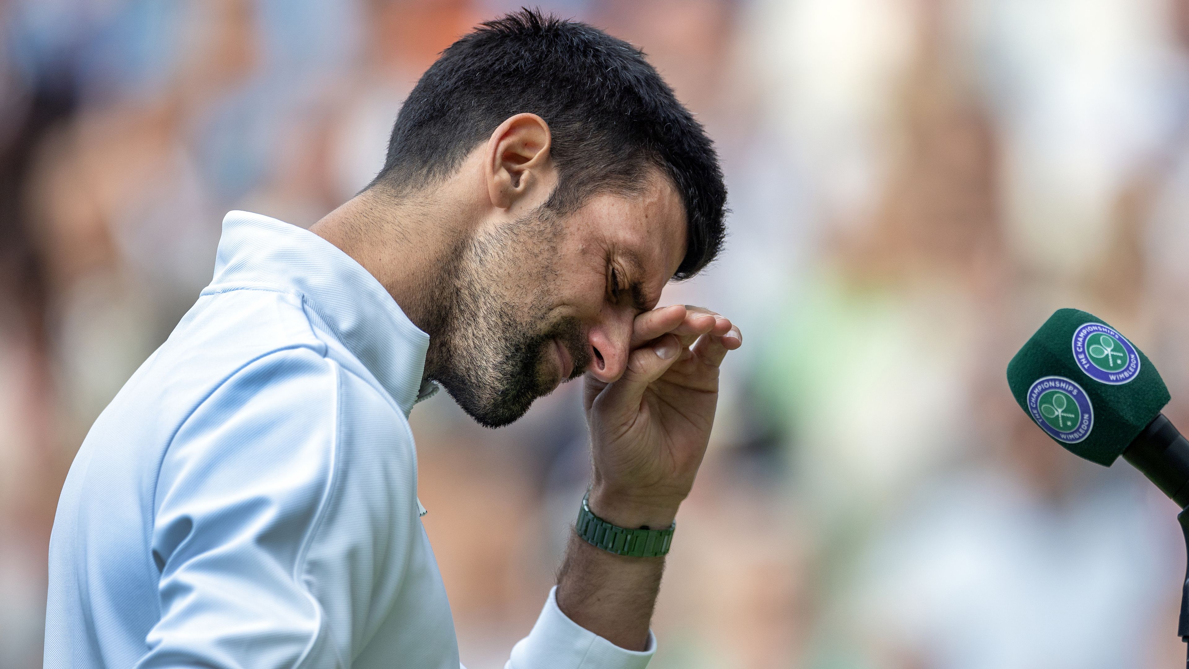 Novak Djokovic of Serbia is overcome with emotion during his speech at the trophy presentation.