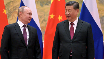 Chinese President Xi Jinping, right, and Russian President Vladimir Putin talk during their meeting in Beijing, China, Friday, Feb. 4, 2022. 